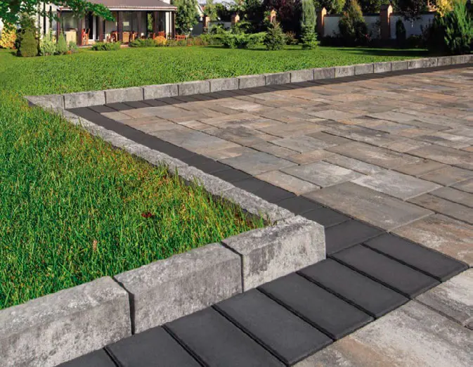 Belgian curbstone bordering a freshly installed paver driveway