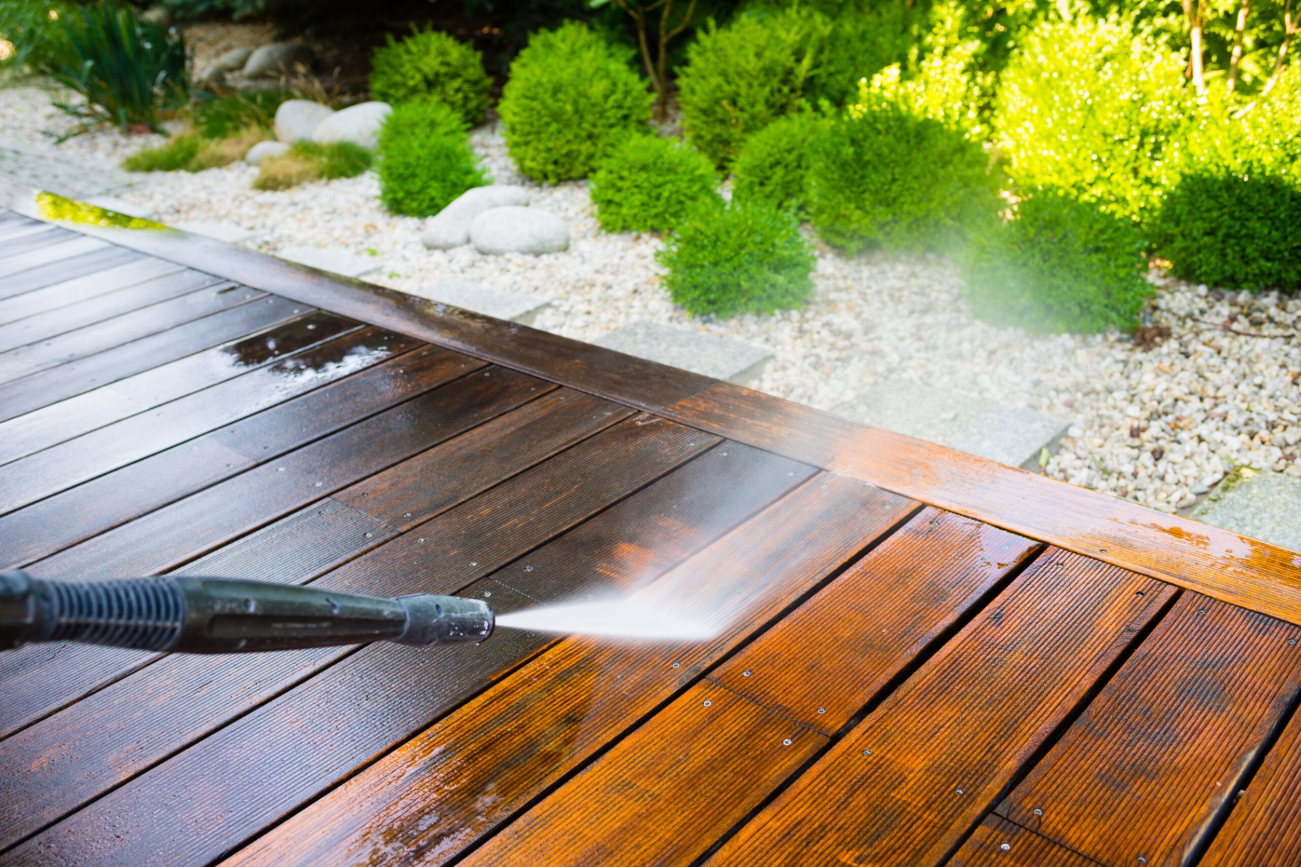 Power washing restoring a wood deck to like-new condition